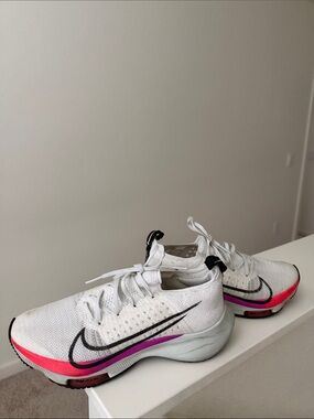 Nike White Running Shoes with Pink Accent and Black Swoosh